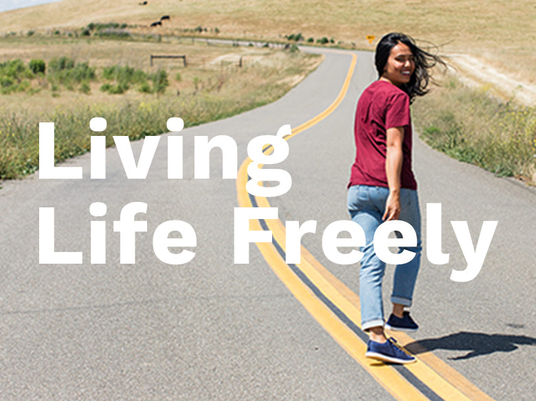 Living Life Freely.  Woman wearing Zilker sneakers walking freely down a road.