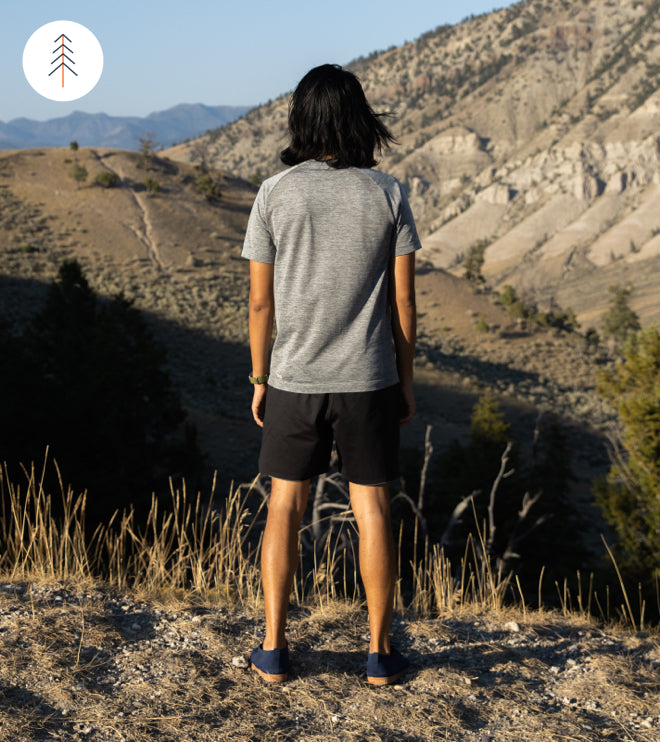 Image of person wearing SUAVS Zilker sneakers, staring into horizon in nature.