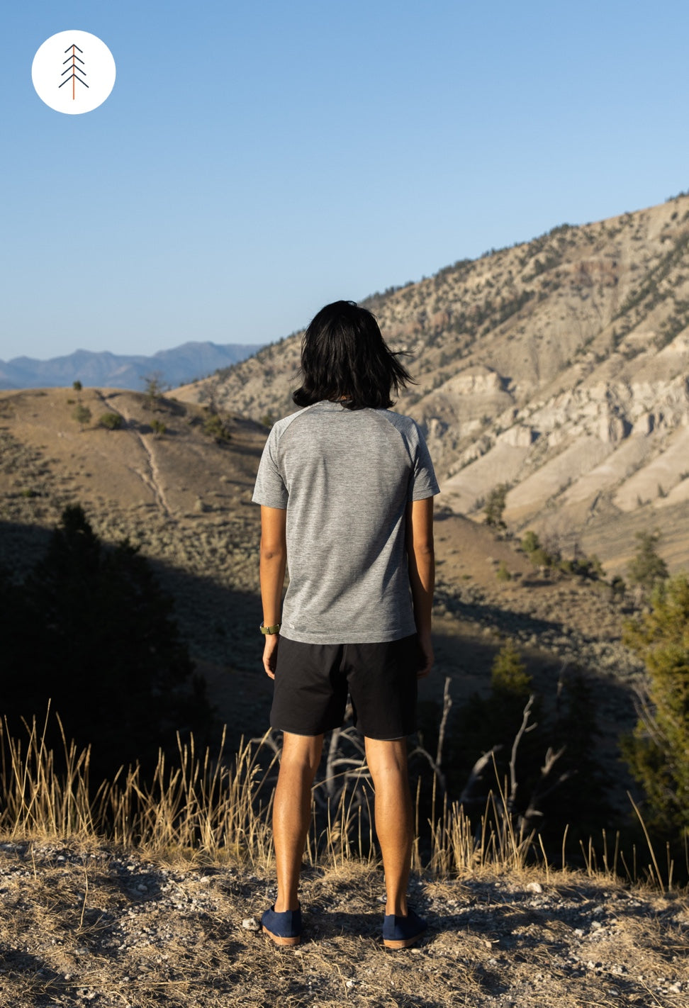 Image of person wearing SUAVS Zilker sneakers, staring into horizon in nature.